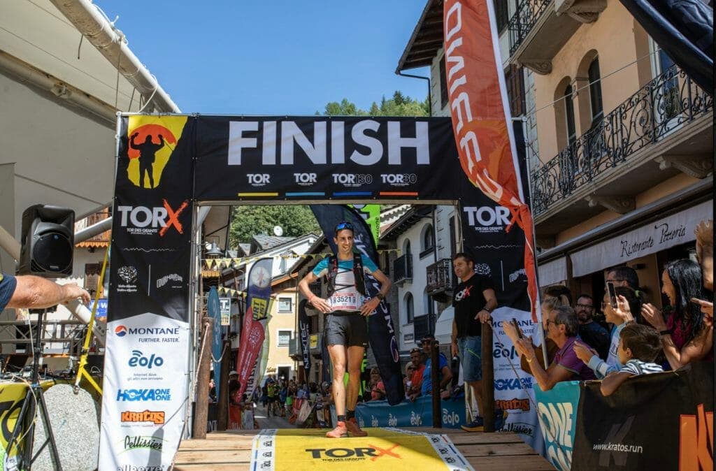 Tor finishers run up a yellow ramp in Courmayeur, Italy.