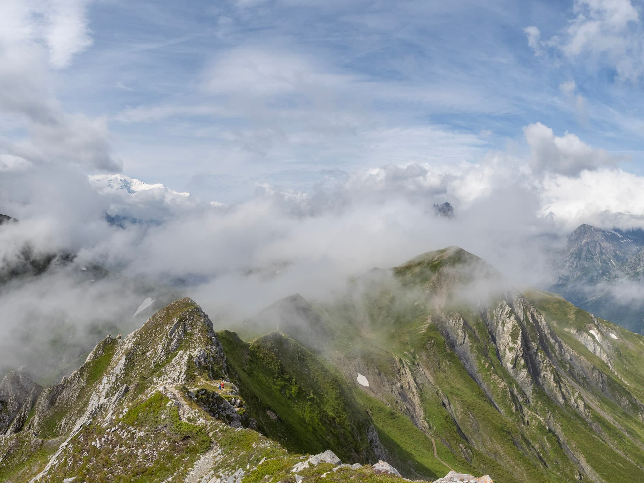 Grassy mountain ridge line with clouds