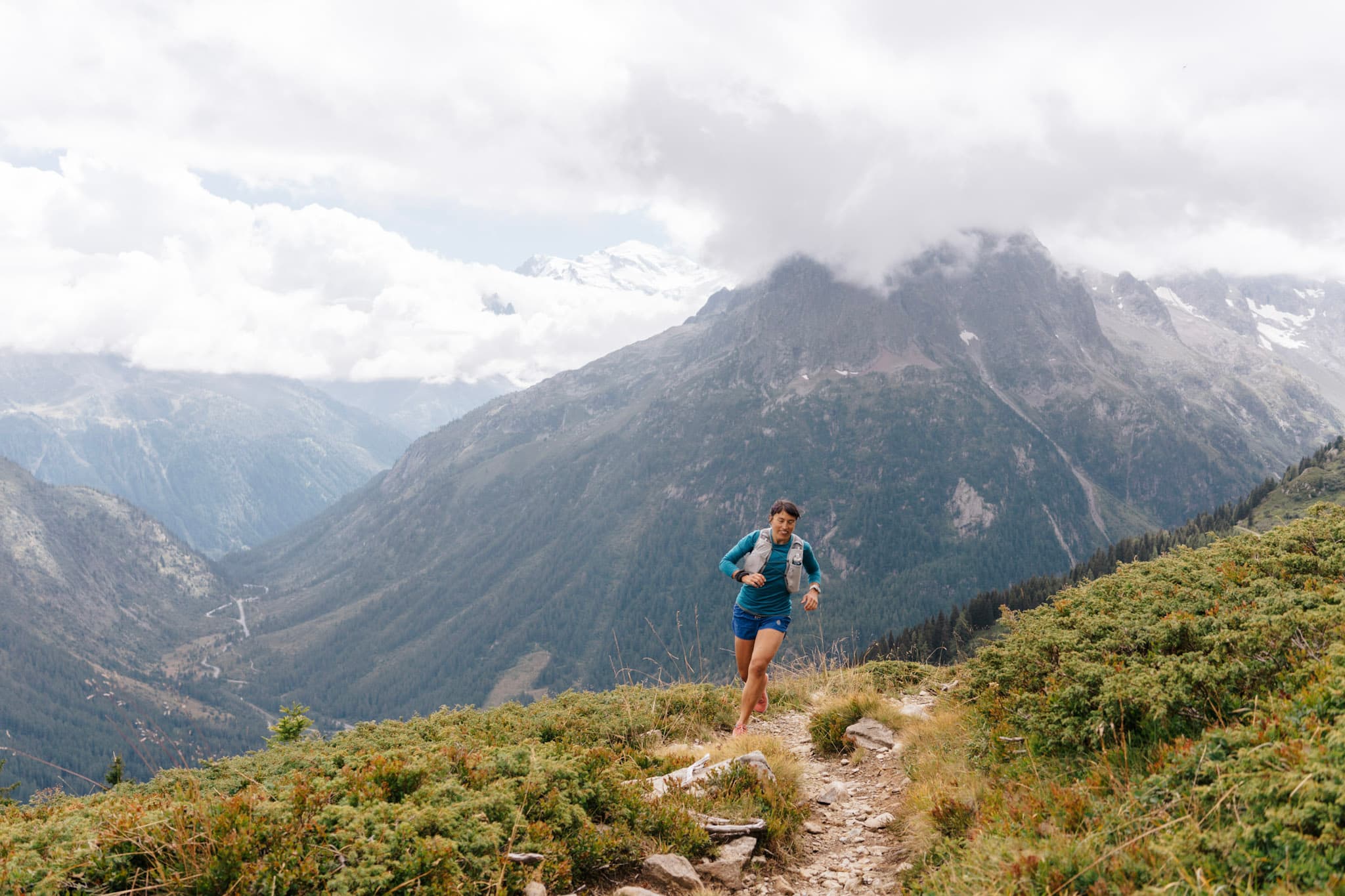 Runner runs along mountain single trail