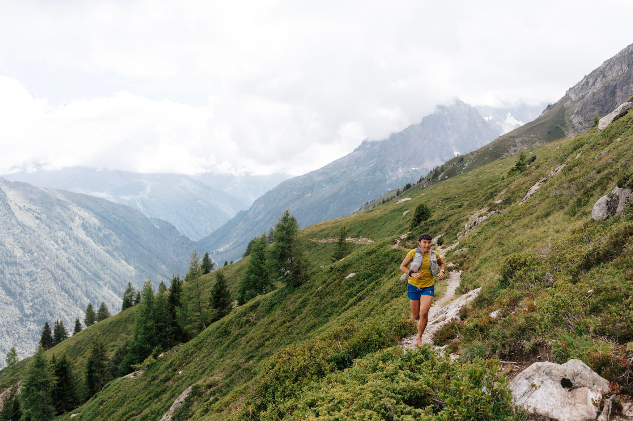 Runner runs along single track just out of the treeline