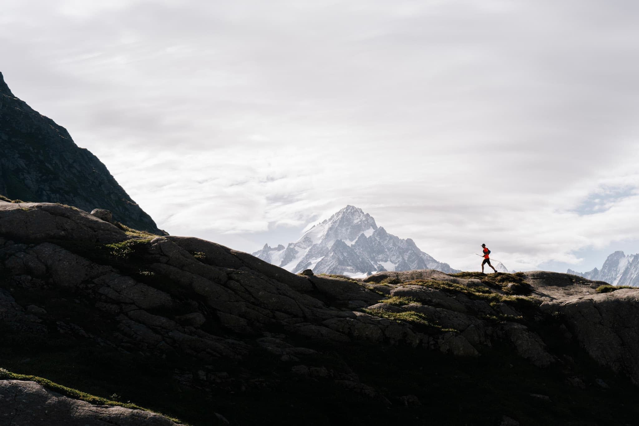 Runner silhouetted against mountain backdrop