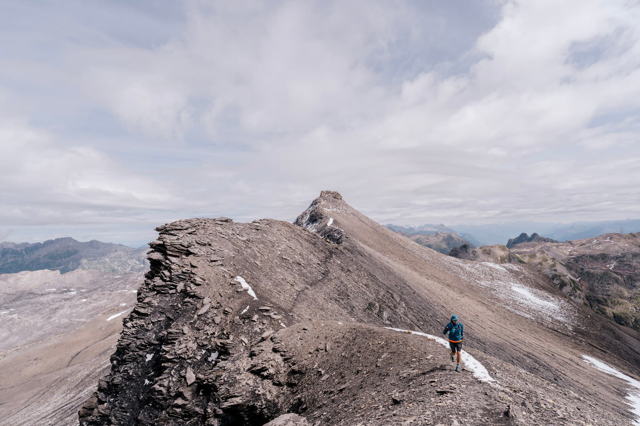 Runner runs along Rocky ridgeline