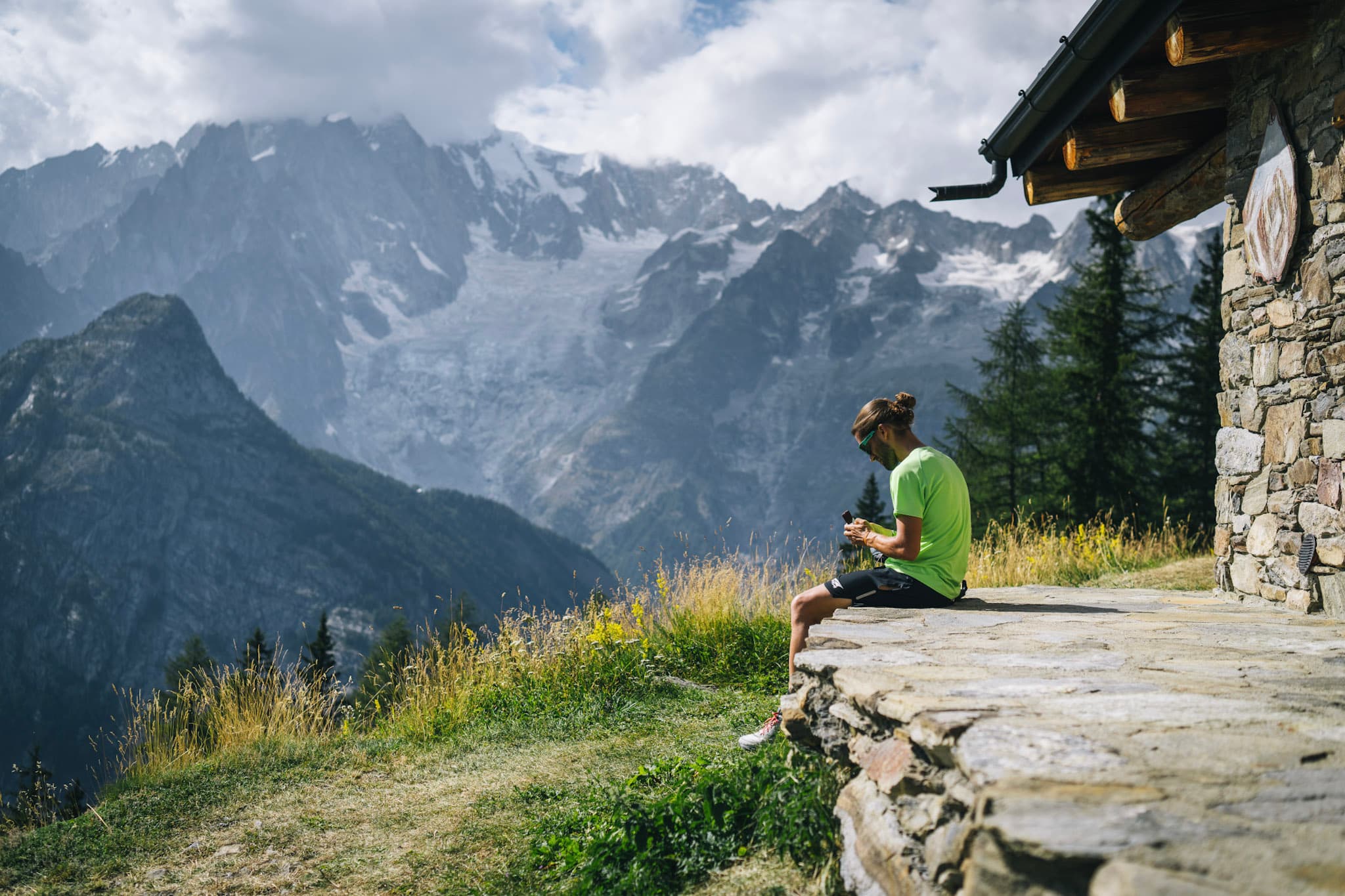 Runner sits next to mountain refuge