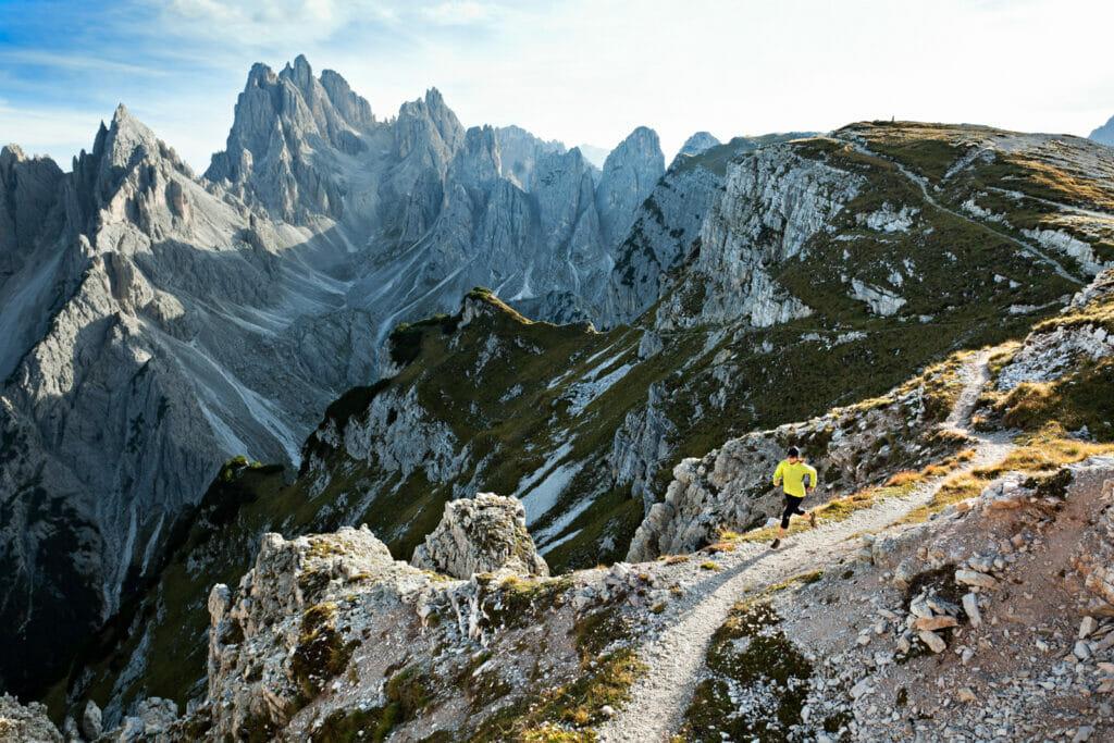 Fall trail running in the dramatic mountain landscape of the Italian Dolomites