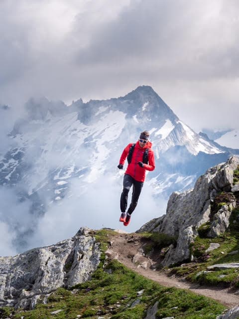 Urs Baumgartner with red jacket at a single trail at the Grimselpass