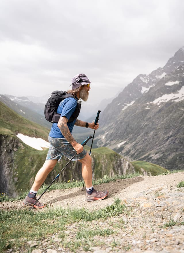 Run the Alps guide, Alistair Crompton hiking up a trail