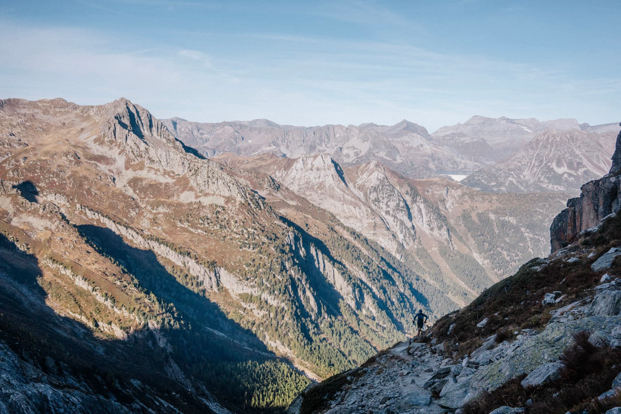 runner silhouetted against rocky mountains