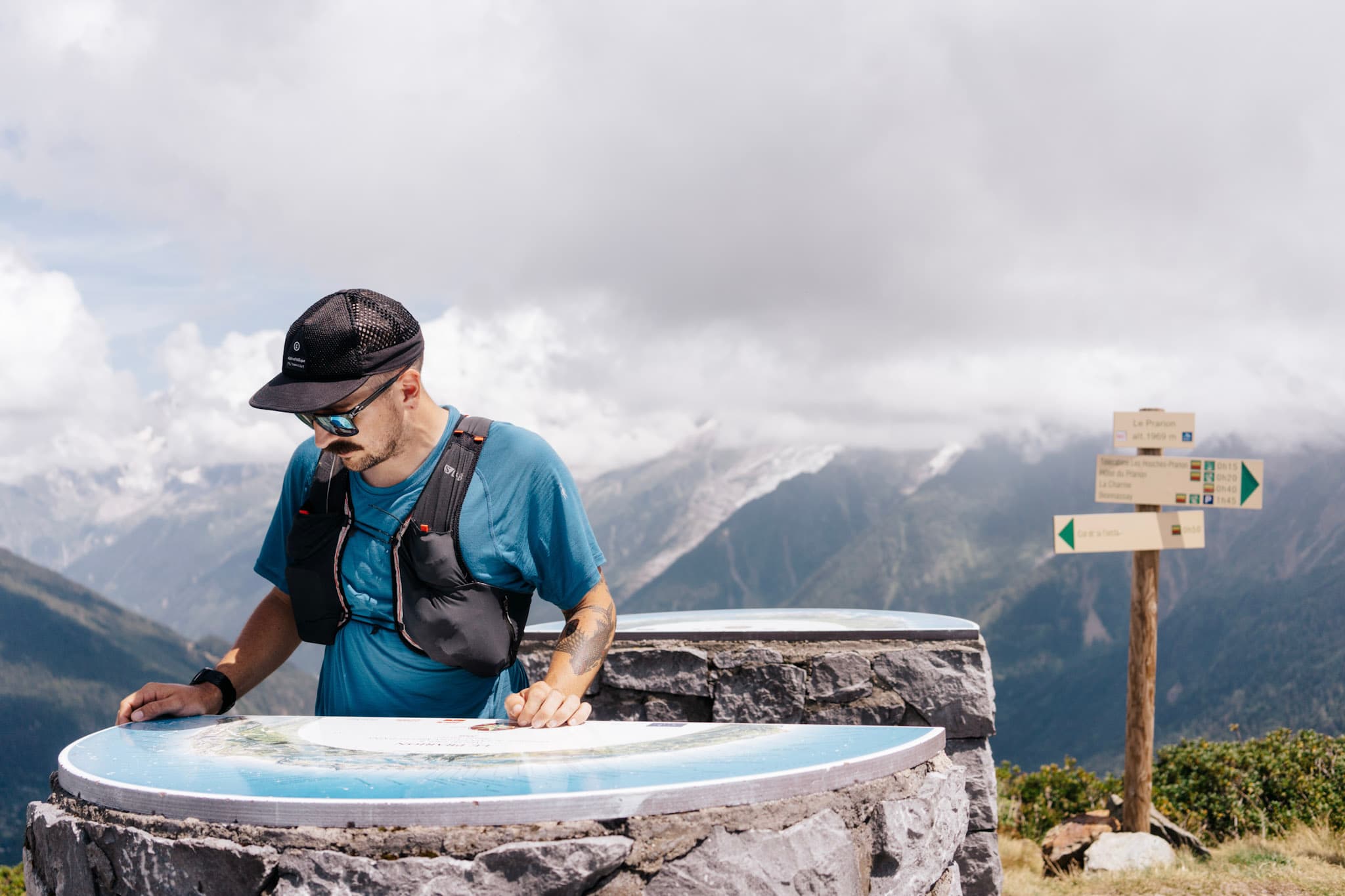 Runner at summit looking at map board