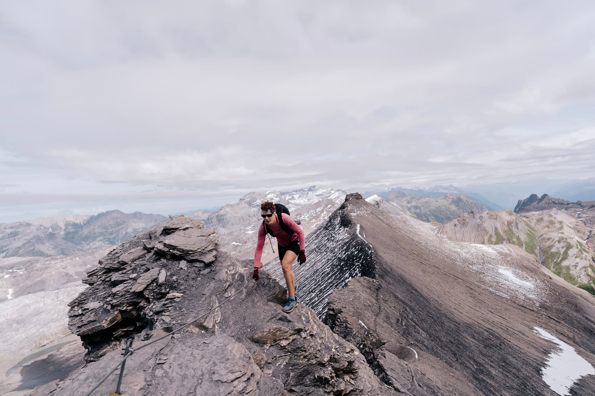 One runner scrambles up rocky ridge line