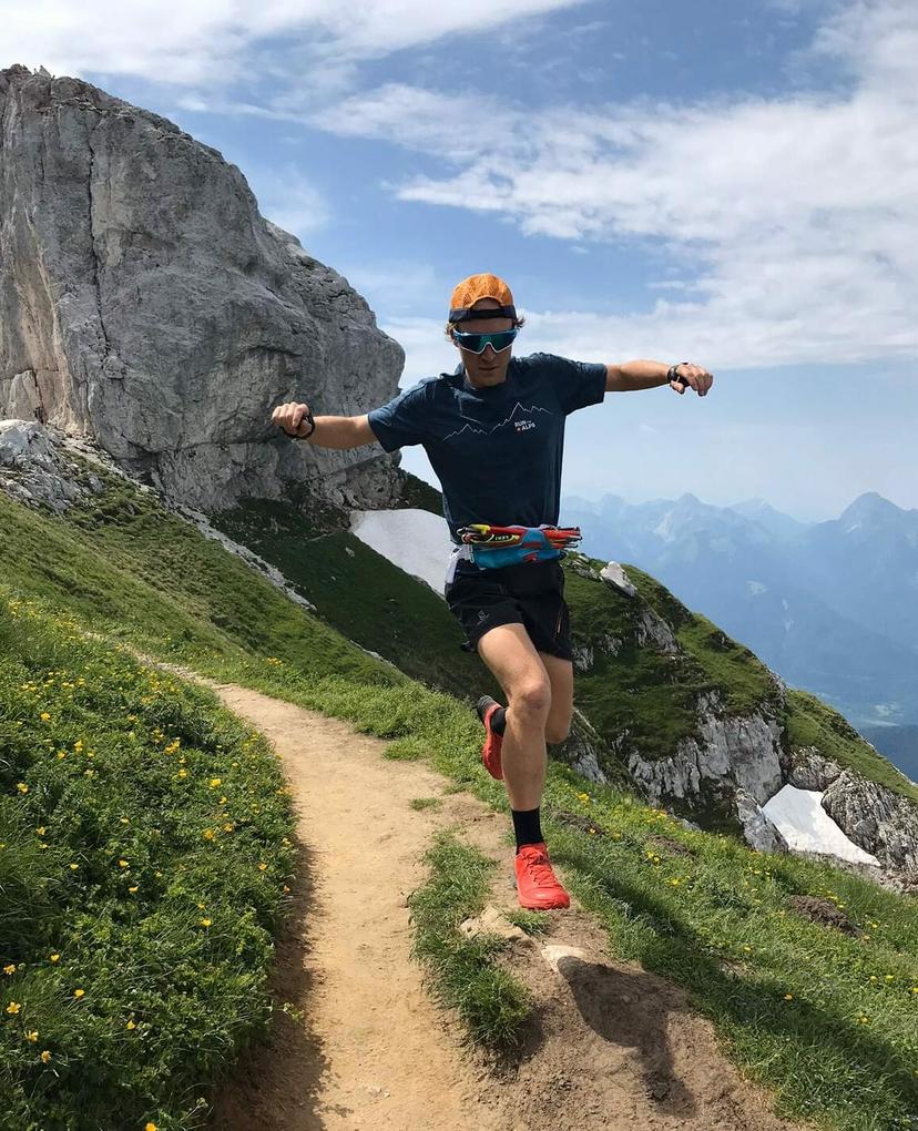 Mike Ambrose with Run the Alps shirt and poles at his belly