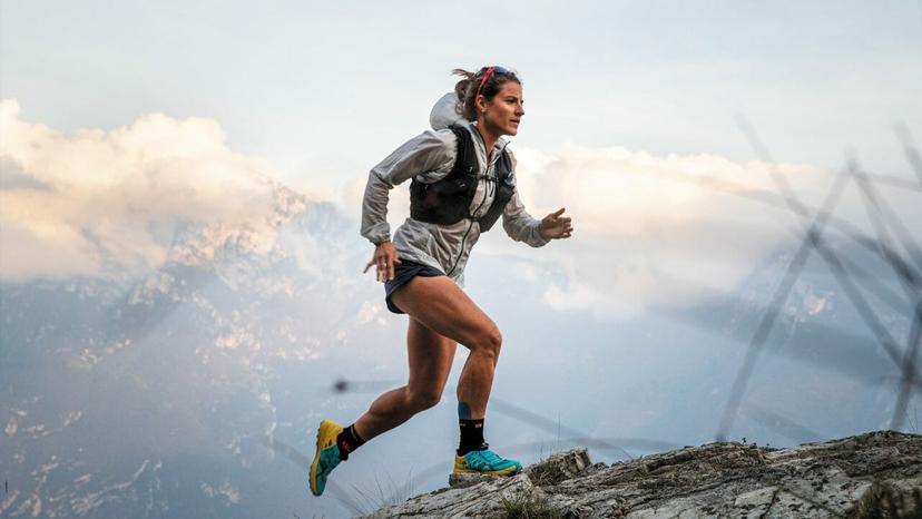 Hillary Gerardi in shorts, with white jacket and black trail run vest