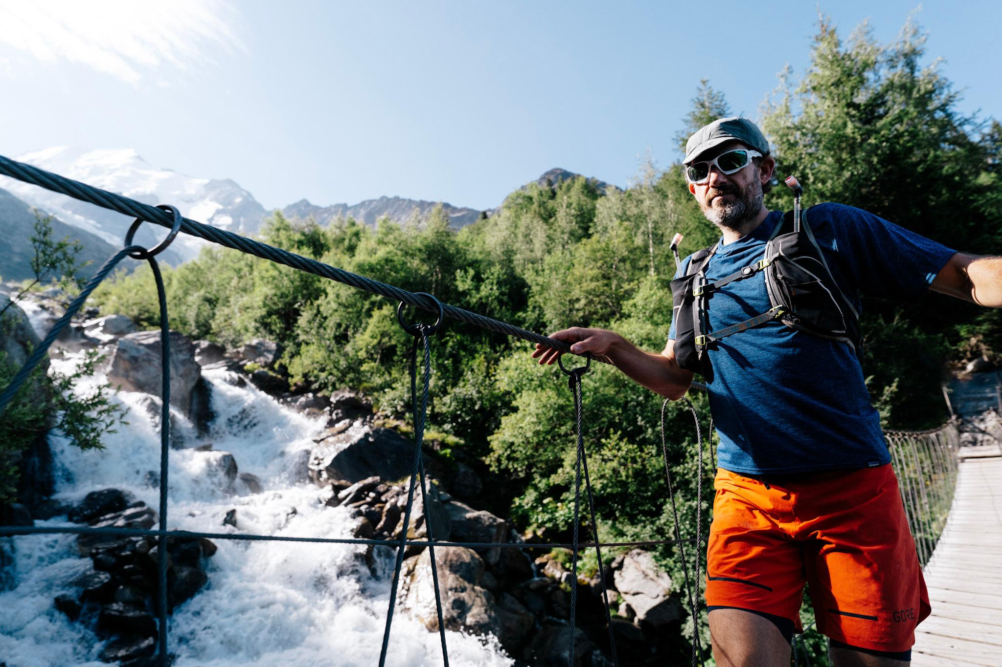 1 runner crossing suspension bridge over river