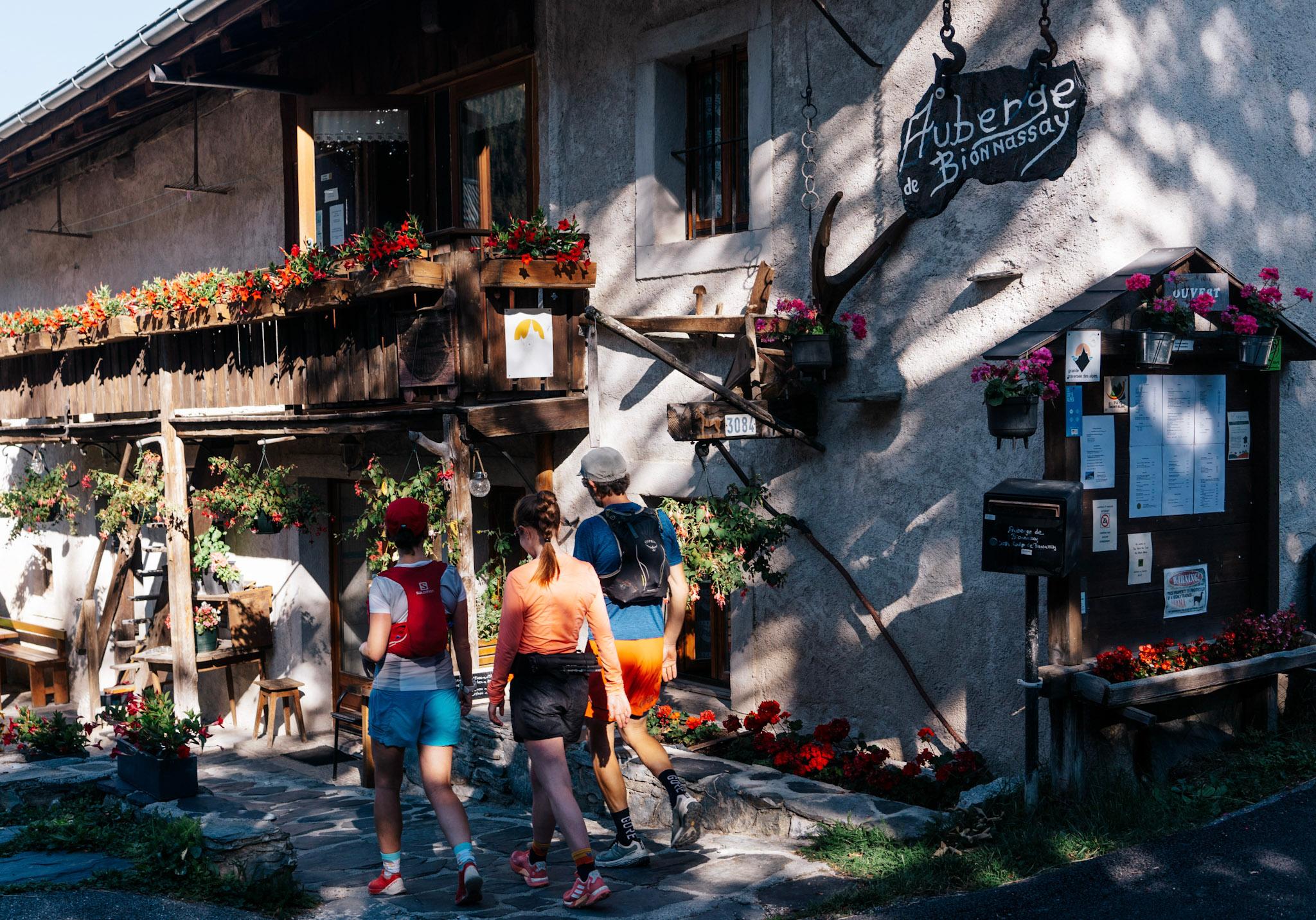 3 runners walk towards mountain restaurant