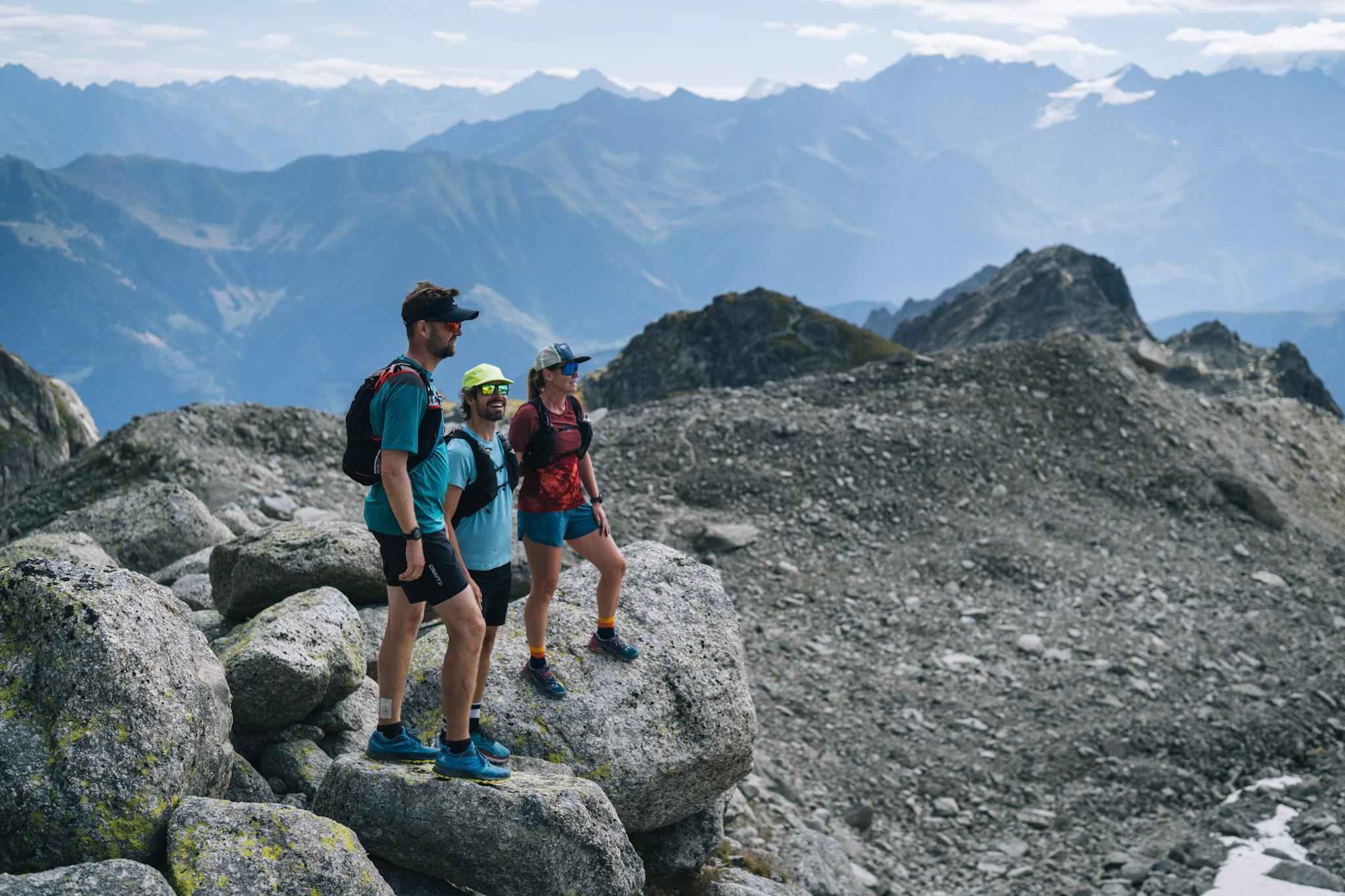 3 runners stop on rocks to look at the view