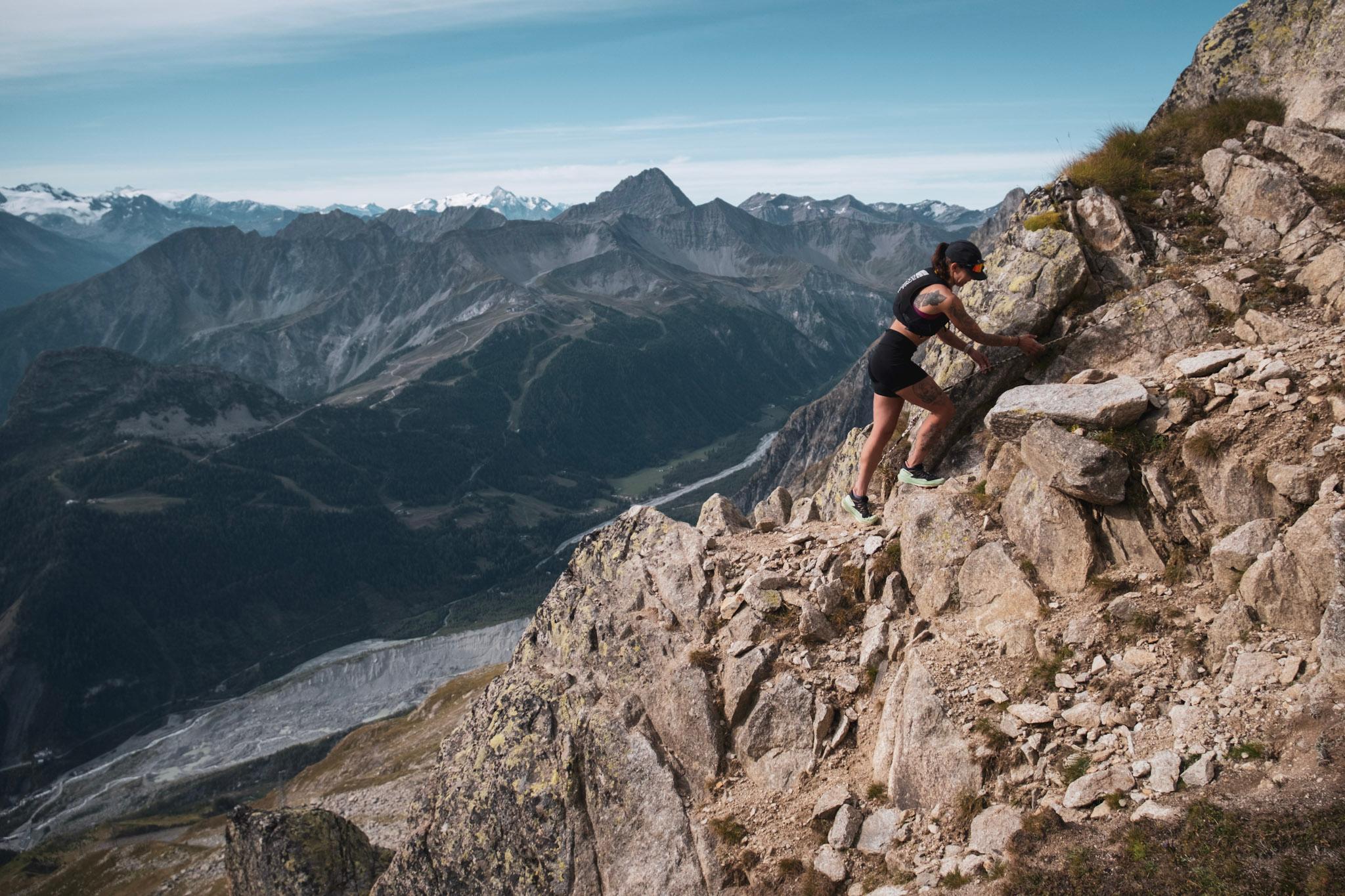 runner scrambles across rocky terrain