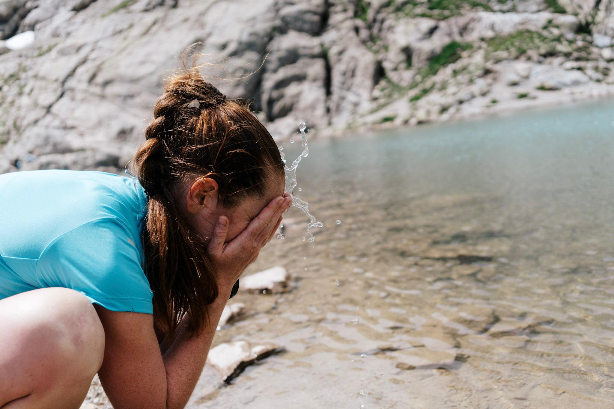 Run out, stops to splash water from lake on face