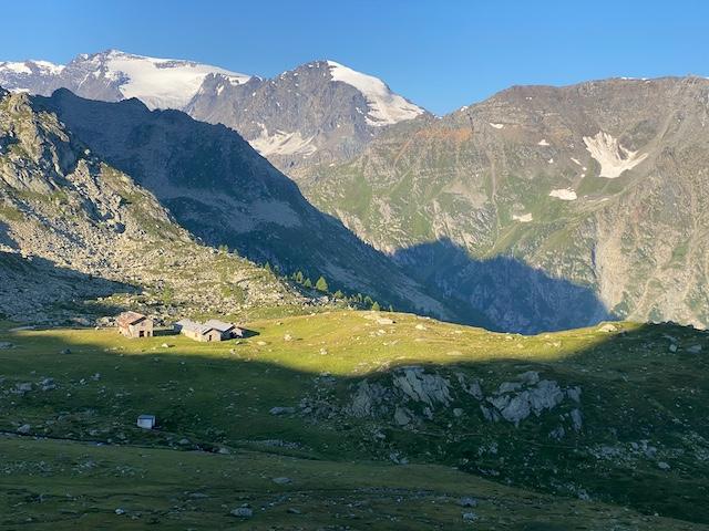 Old stone buildings high in the Alpine pasture in the Gran Paradiso National park