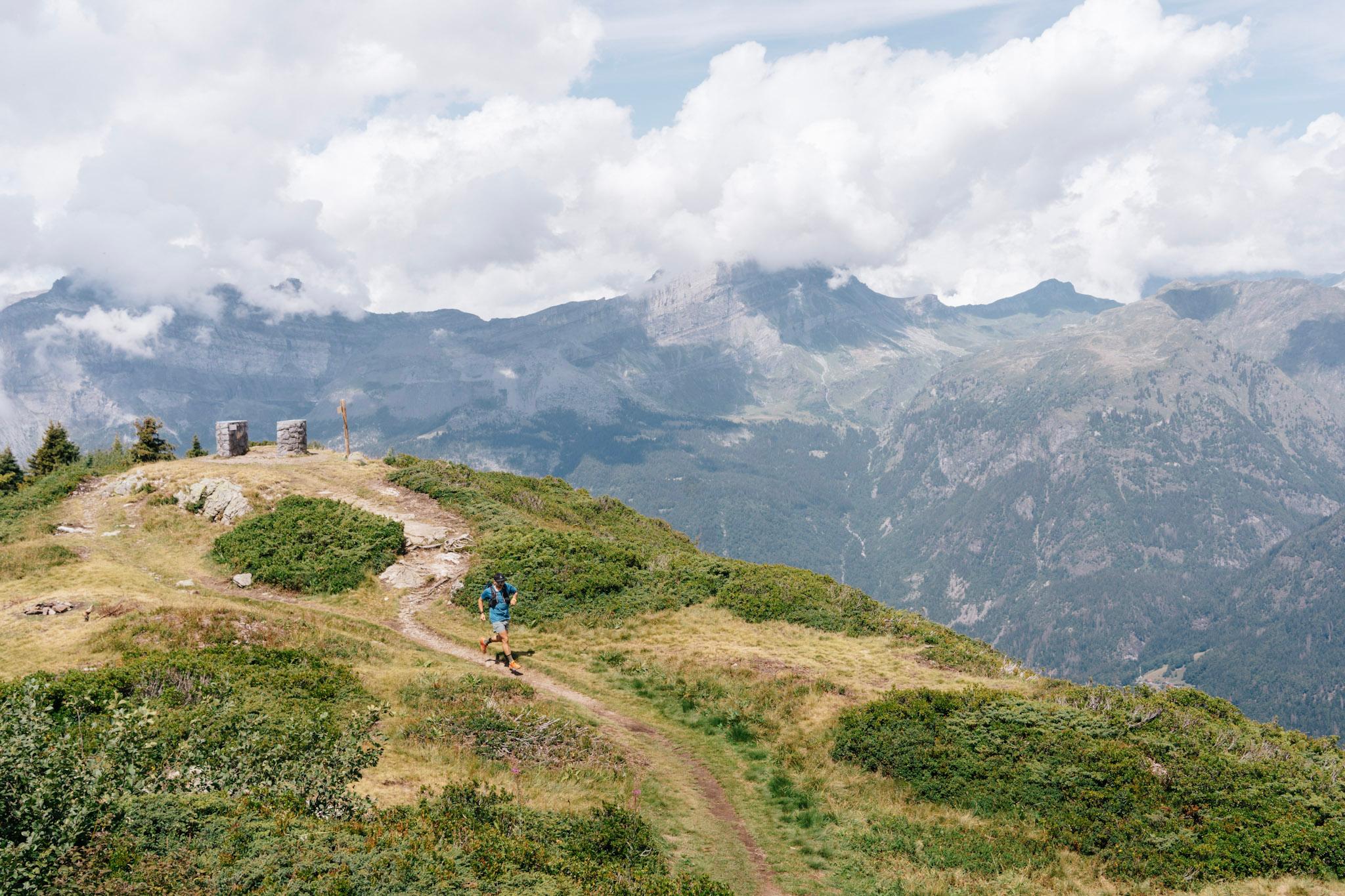 Runner in distance on flowing single track