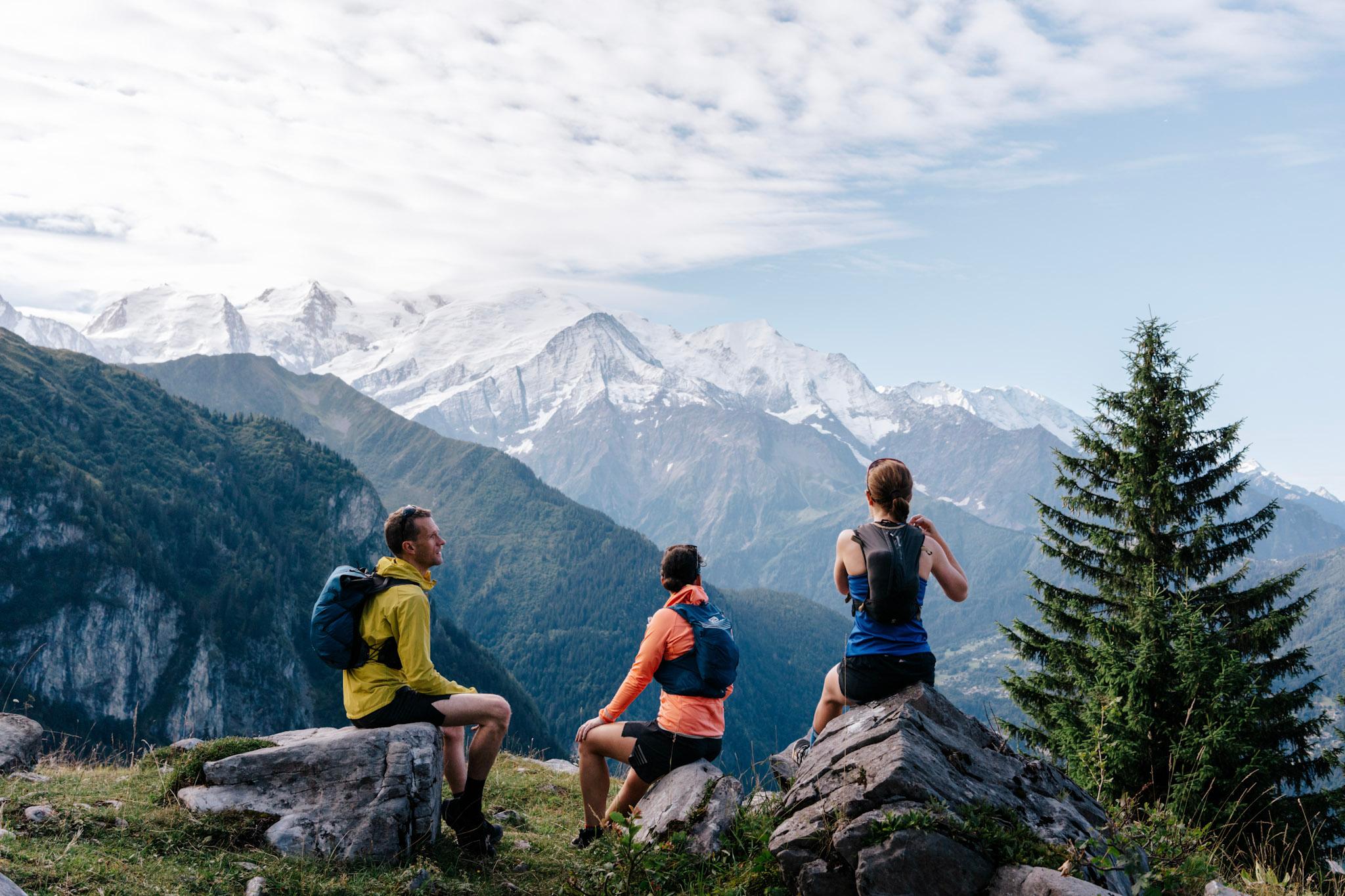 3 Runners sat looking at the mountains