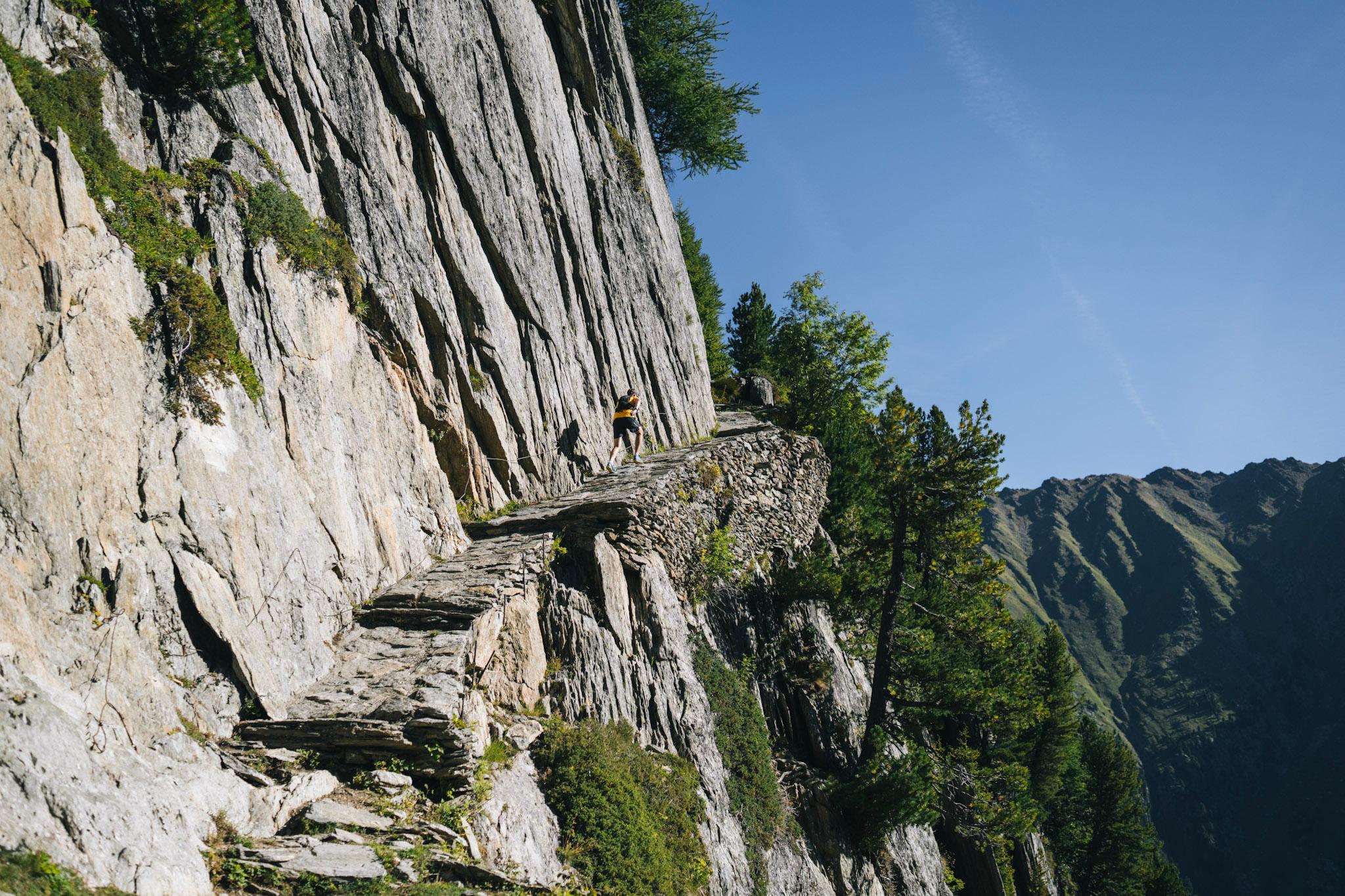 runner hike up hill on rock stops built into the cliffside