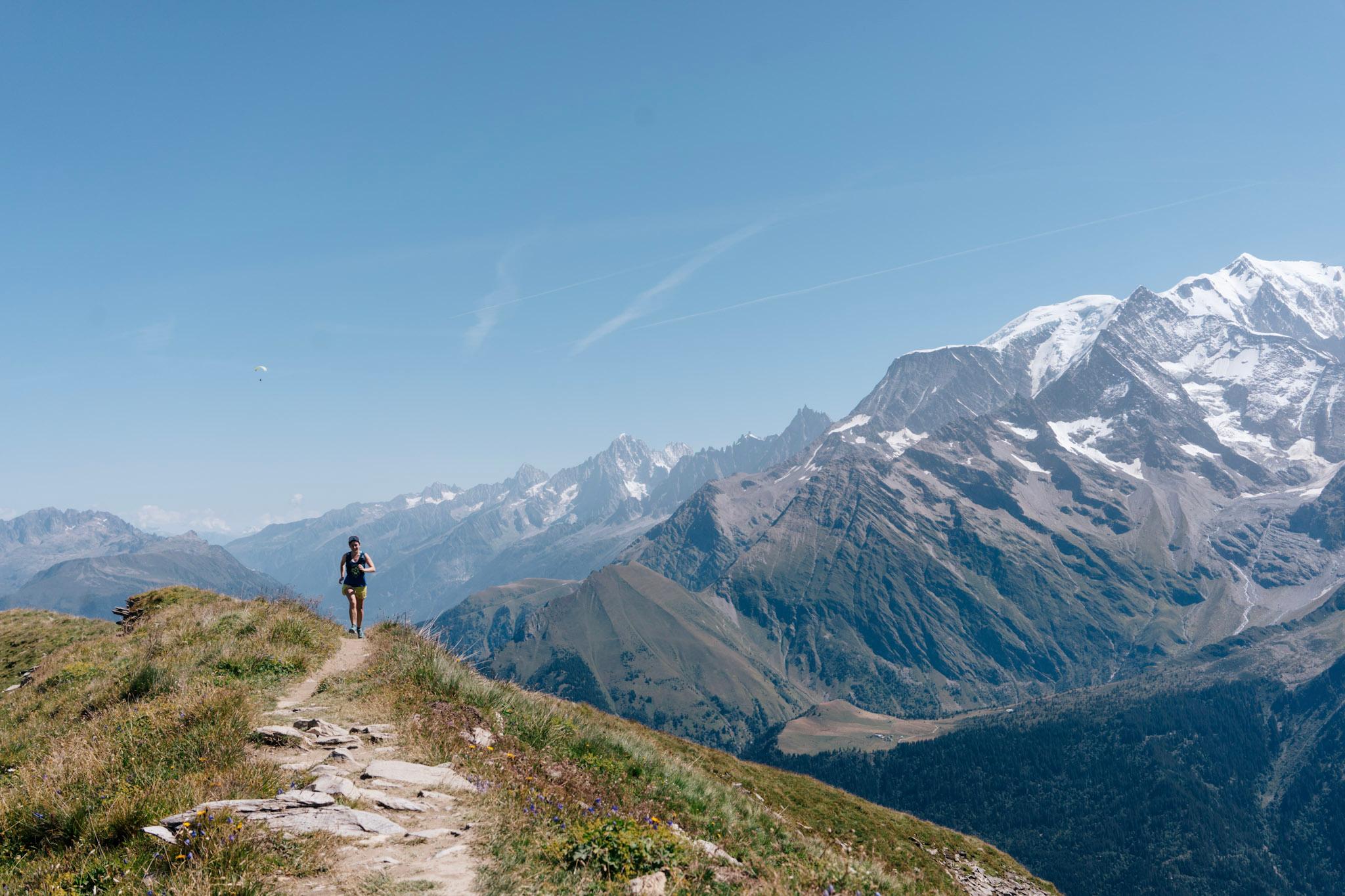 one runner in the distance on single track trail