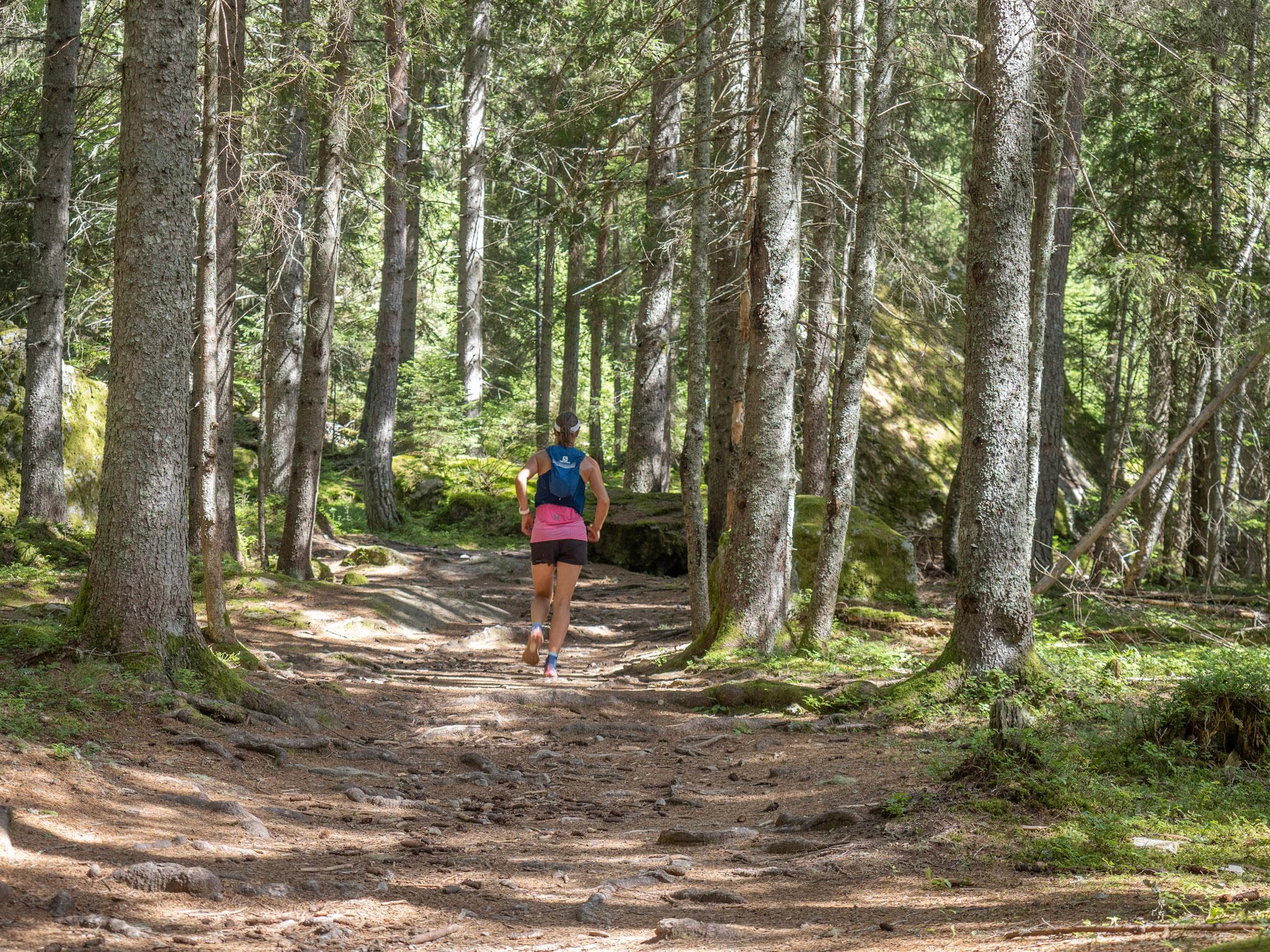 Runner runs up Hill in Forest