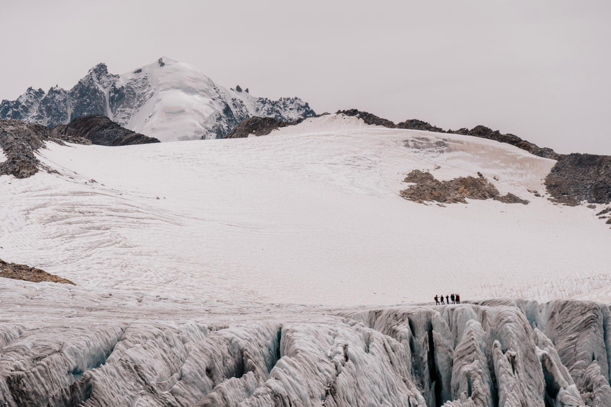 people stood on glacier in the distance