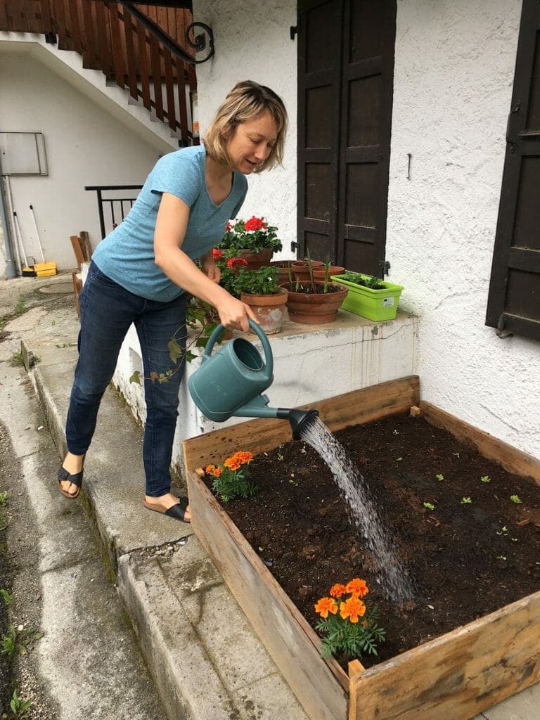 Run the Alps Guide Emily watering plants during Covid confinement