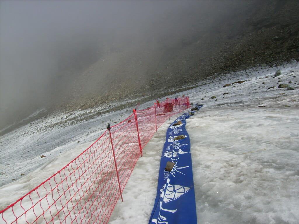 Anyone for a magic carpet ride? Race organizers kept the route slide-free by adding a textile fabric and fencing on a steep section of the glacier. Photo courtesy of Fabian Manceau.
