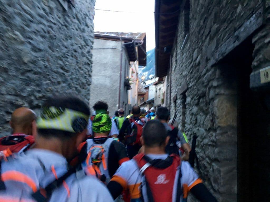 Through the narrow streets of Dolonne, Gran Trail Courmayeur heads for the hills. (Photo by author.)
