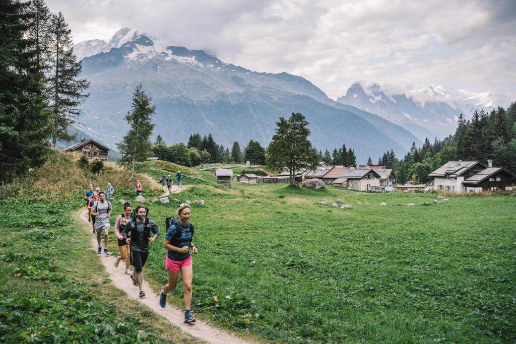 trail runners in a field in the alps