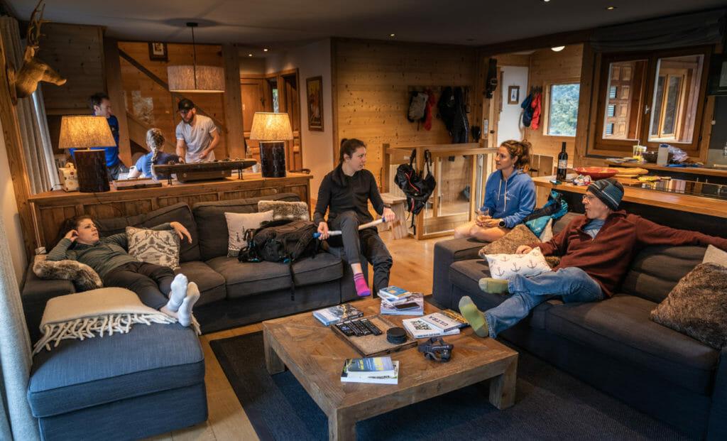 People hanging out in large chalet living room.