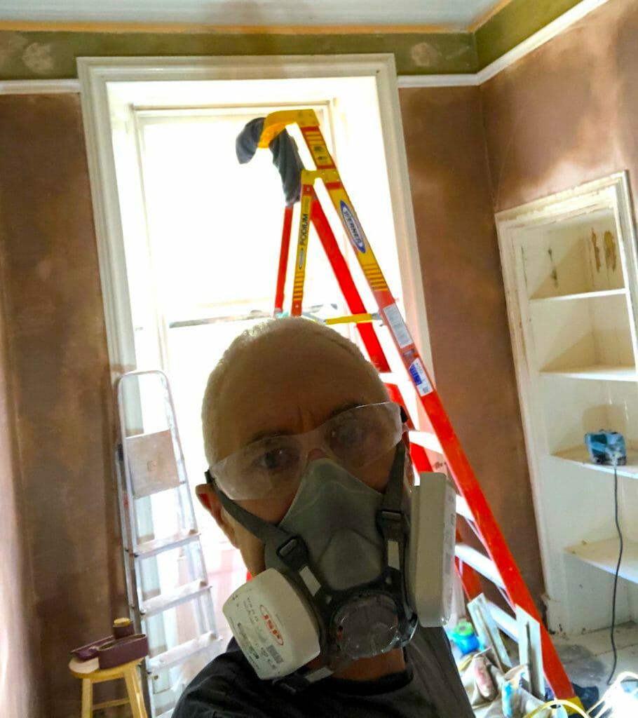 Giles with a full protection mask, renovating his house