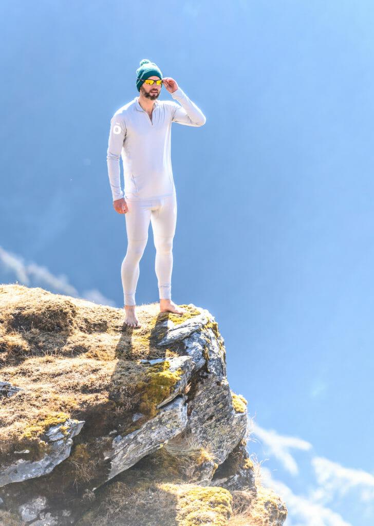 Mark Brightwell in a white baselayer on a rock