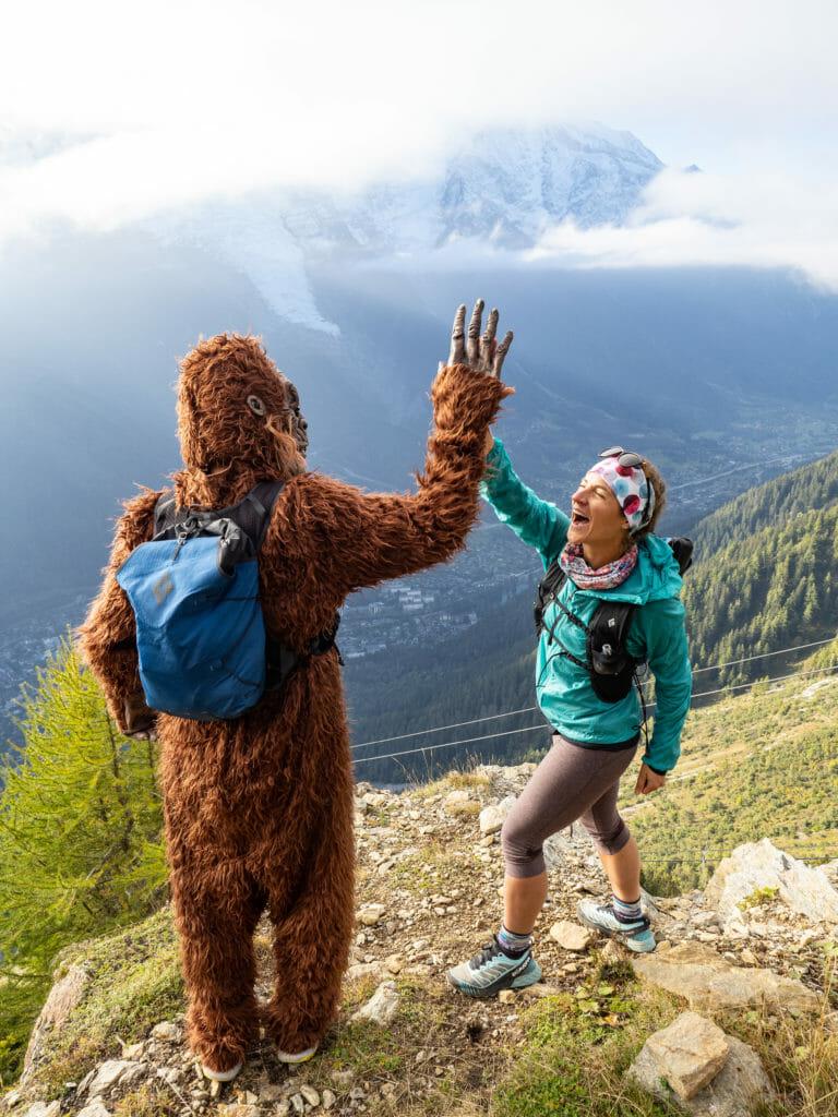 Bigfoot with blue bakcpack and Hillary doing an high five