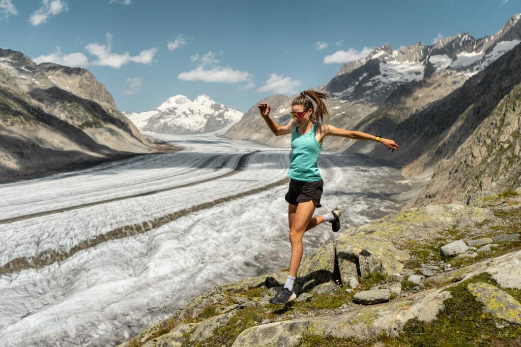 A female runner runs alongside the Aletsch glacier near Bettmeralp, Switzerland. 