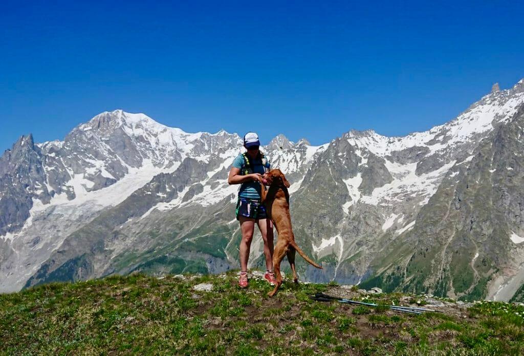 Run the Alps guide Suze Walker and her dog, Obi in Val Ferret, Italy, with Mont Blanc in the background