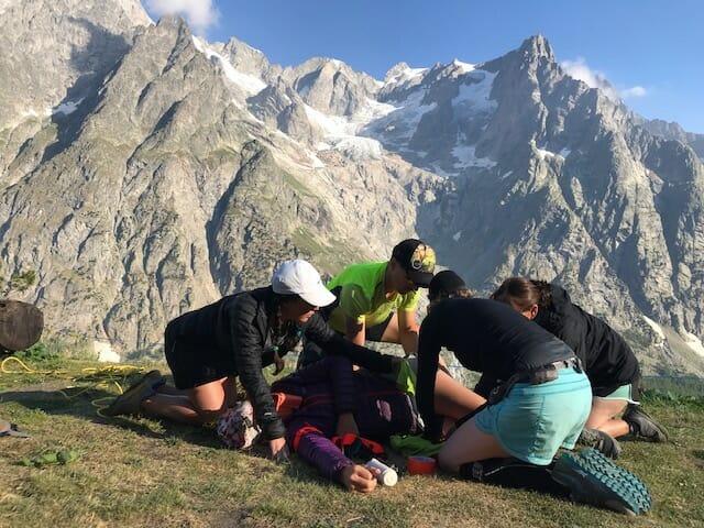 One subject and four helpers during Wilderness medical in front of the Mont Blanc Massif from the Italien site