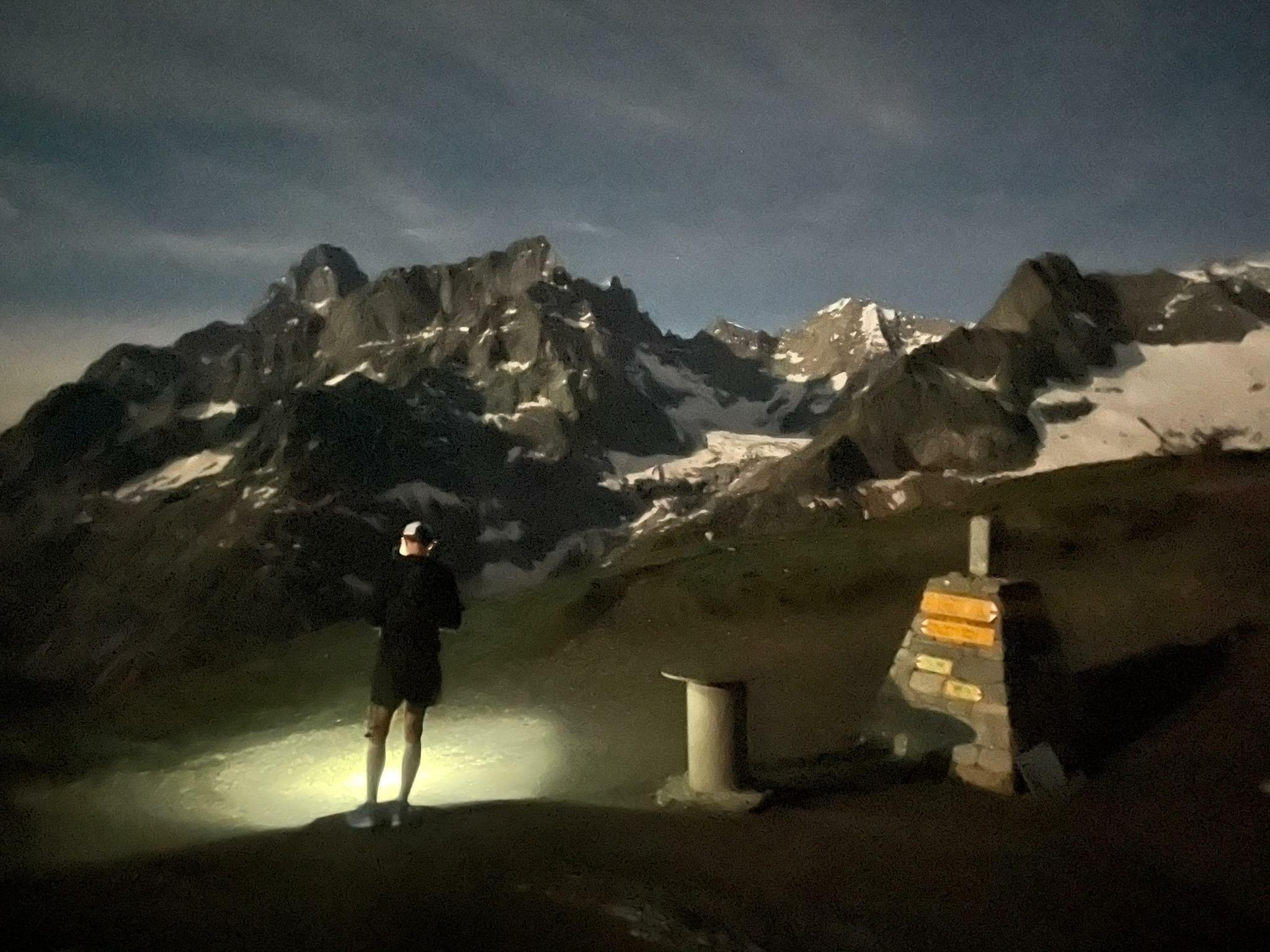 Night at Grand Col Ferret on Mont Blanc, with a trail runner looking into the distance