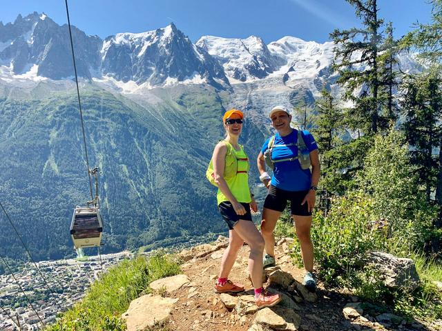 Two trail runners on the vertical km above Chamonix, with Mont Blanc in the background