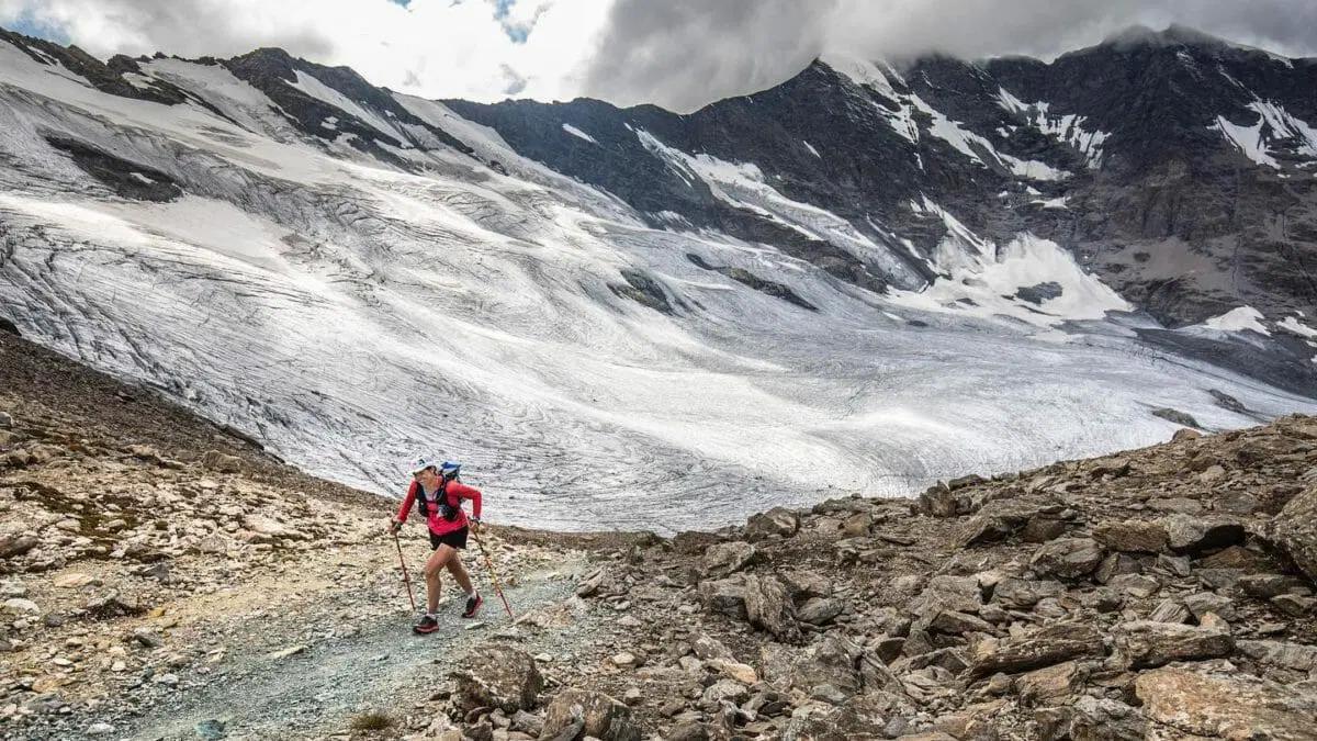 Stephanie Case trail running through high country close to a glacier