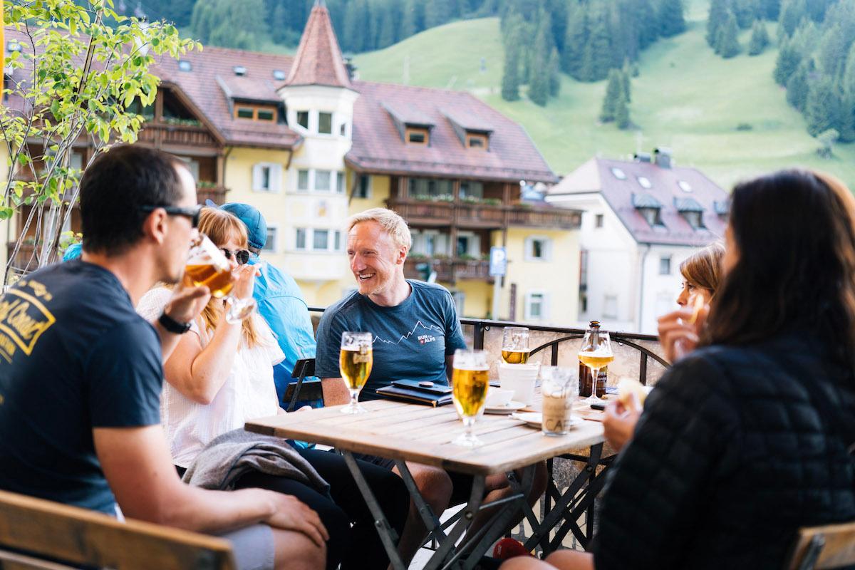 A group of people enjoying aperitif in the Dolomites